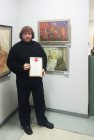 Alexey Akindinov at the pictures, with the diploma handed to him. Opening of the anniversary Regional art exhibition \"Fall — 2015\" 