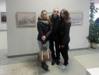 Artist Alexander Kovalev and visitors of the exhibition on the background of his paintings. The opening of the Jubilee Regional Art Exhibition \"Autumn - 2015\", 