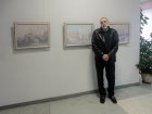 Artist Alexander Kovalev on the background of his paintings. The opening of the Jubilee Regional Art Exhibition \"Autumn - 2015\", dedicated to the 75th anniversary of the Ryazan branch of the Union of Artists of Russia. October 23, 2015. Exhibition Ha