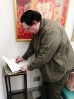 Alexey Akindinov signs the catalog with his paintings. Opening of the personal exhibition \"Ornamental Reality\". Art Gallery \"Prio-Vneshtorgbank\", Ryazan.