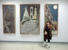 Against the background of paintings by Yuri Kuznetsov - caretaker Showroom CXP - Lyuba. The exhibition \"A look at the artist Ryazan\", February 5, 2016. The exhibition hall of the Union of Artists of Russia, Ryazan.