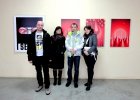 Художники: Александр Епифанов со своей супругой Юлей и Александр Суханов со своей знакомой у своих работ.