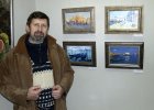 Artist Oleg Potapov near his pictures.
