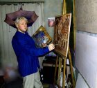 Alexey in the workshop behind an easel and a picture. 2010.